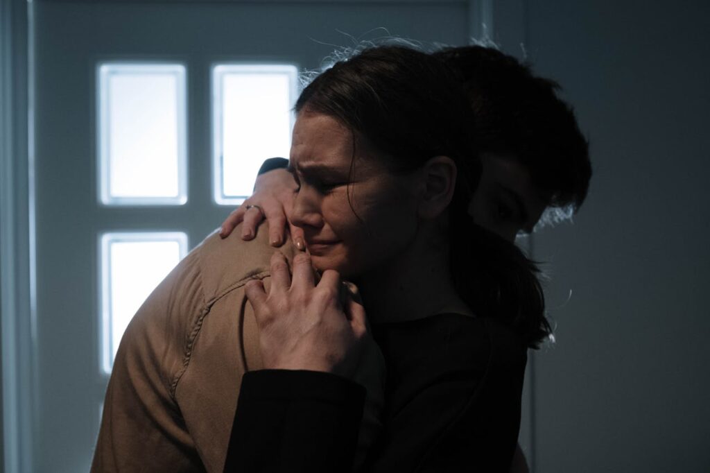 crying woman hugging a man